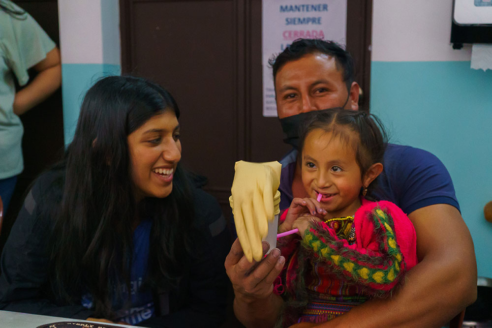 Sarah with a little girl with a cleft and her dad at Tess Unlimited