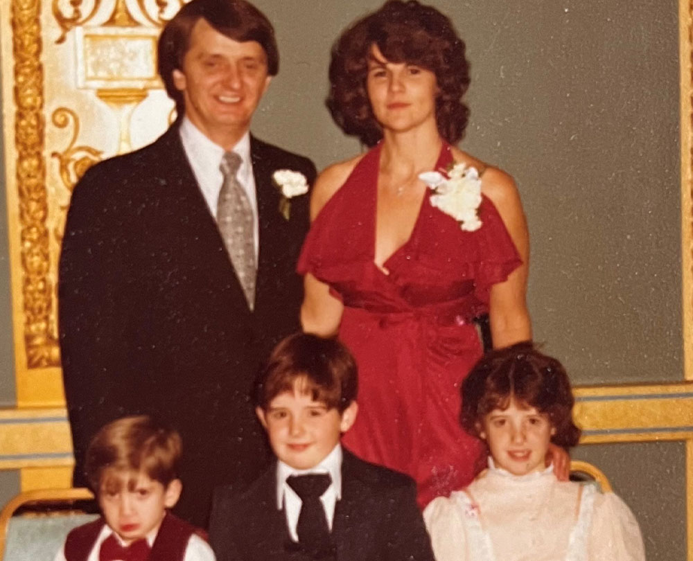 Kate, Robert Bullard and their three children posing for a family photo