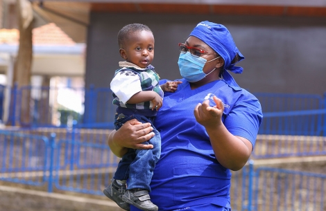 Dr. Amanda Malungo holding a cleft patient after his surgery.