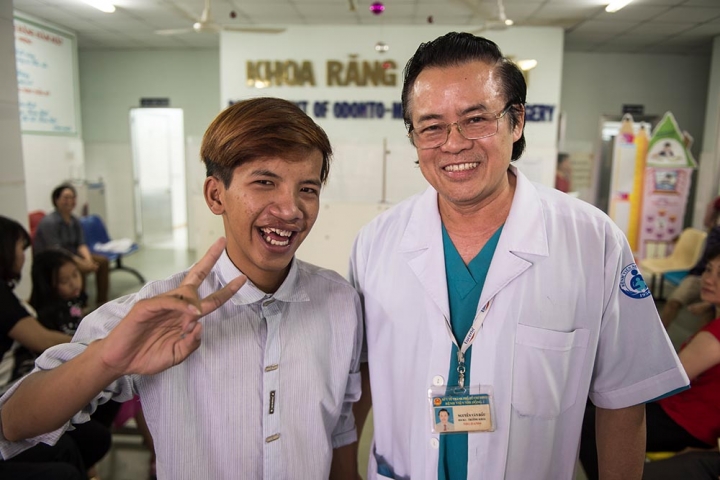 Smile Train doctor next to his happy patient