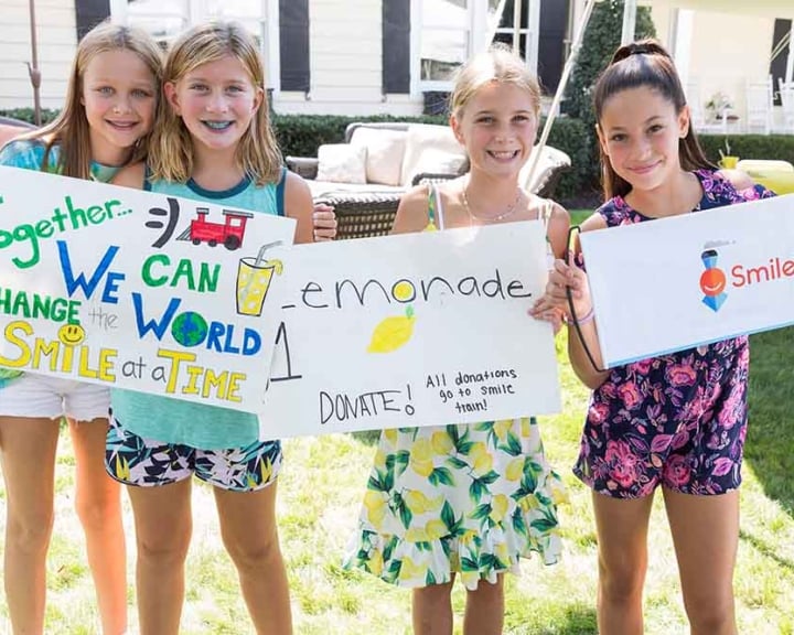Group of children selling lemonade for Smile Train