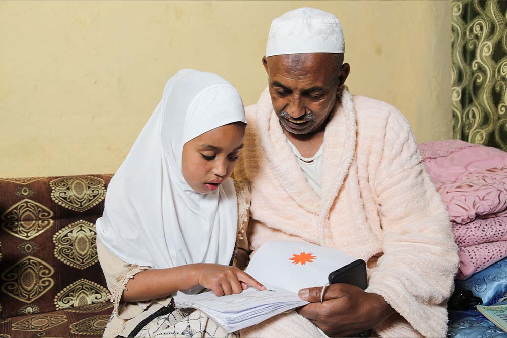 Sabira studying with her father