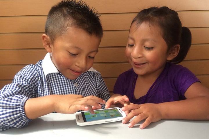 two children playing Smile Train speech therapy app