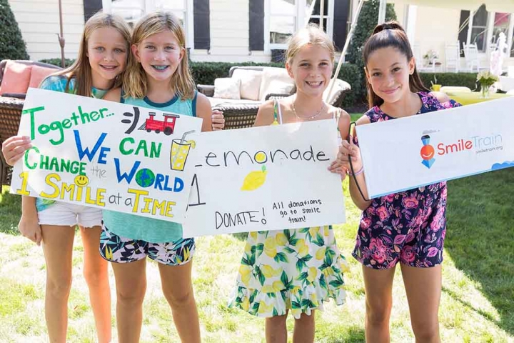 Group of children selling lemonade for Smile Train