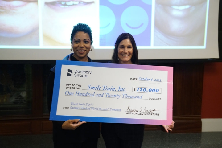 Susie Schaefer holding a big check for $120,000 on World Smile Day