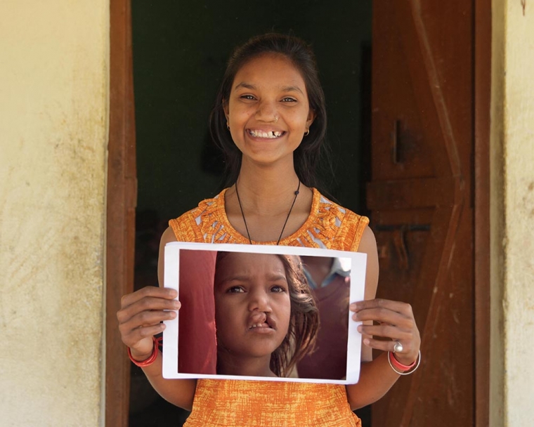 Pinki holds image of herself from documentary film Smile Pinki