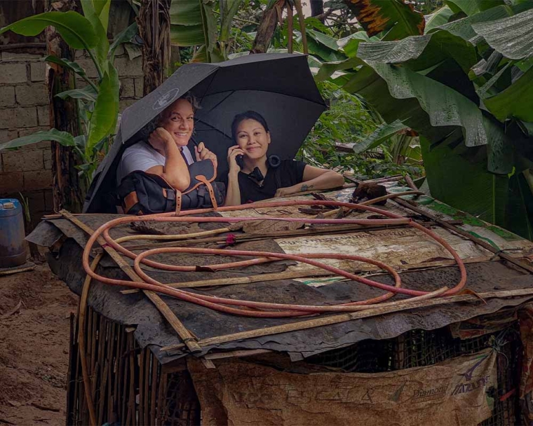 Every Day After Director Elisa Gambino and Producer Elaine Jose Bobadilla smiling under an umbrella